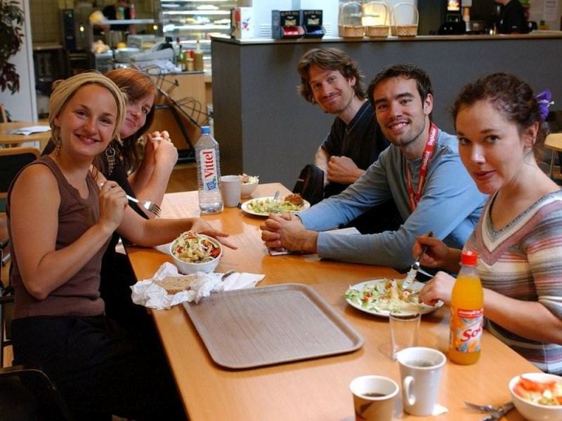 The team of A Doll&#039;s House is having lunch in the canteen at the Norwegian National Theatre (Nationaltheatret) smiling to the photographer.