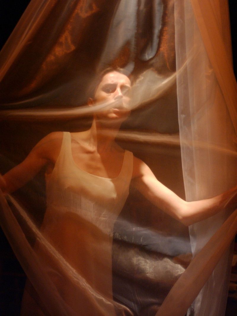 Beate Rosmer is looking through a white gauze suggesting she is invisible observing a situation from the outside.